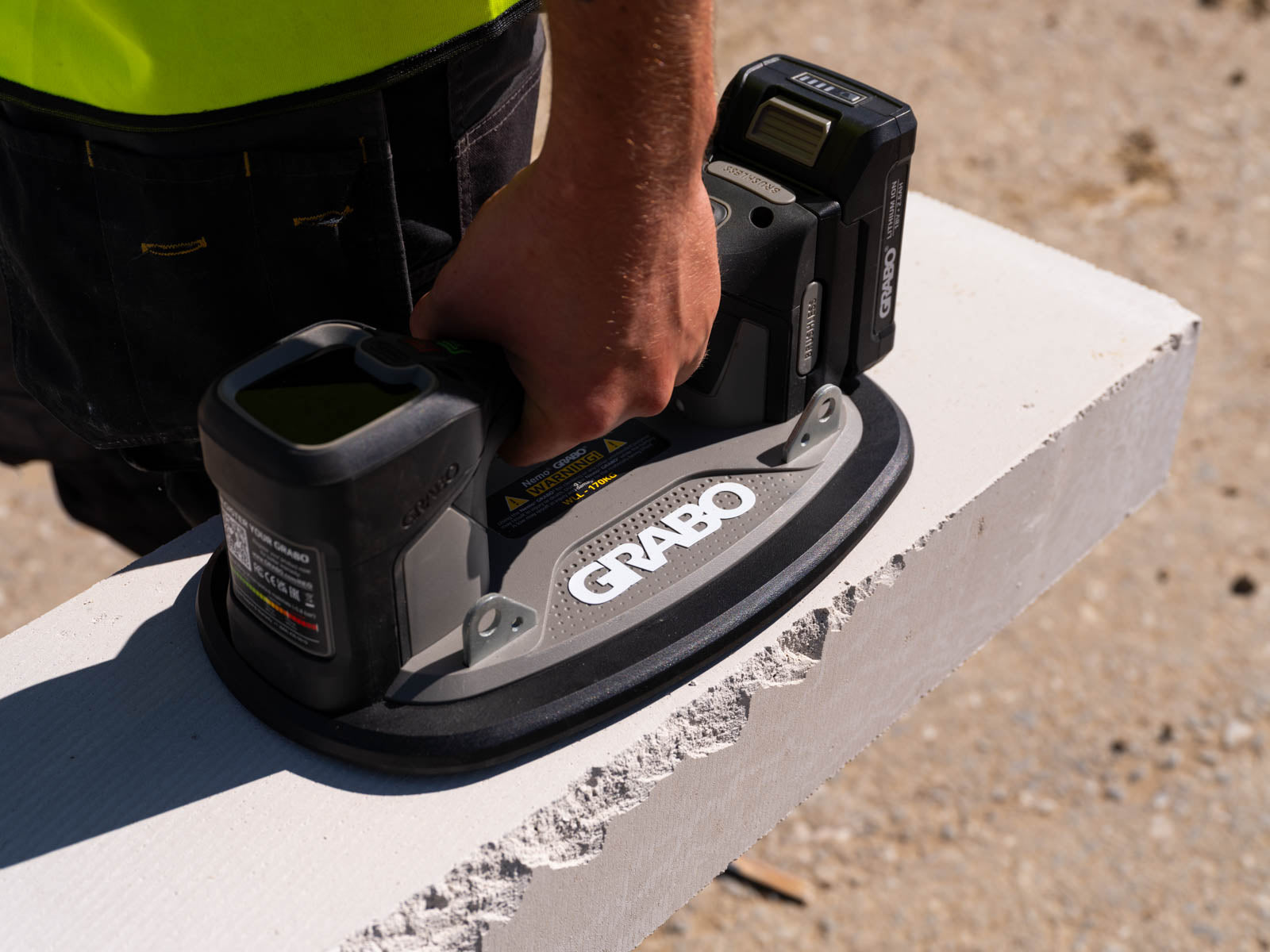 Person using a Grabo power tool on a concrete surface