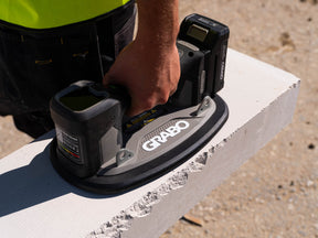 Person using a Grabo power tool on a concrete surface